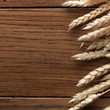 Wheat spikes on wooden board