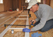 Carpenter adjusting clamp on exterior trim assembly