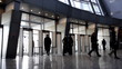 Entrance to modern building and people silhouettes