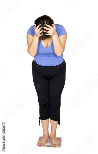 Photo: Woman standing on scales. Woman standing on scales.