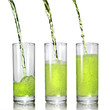 green juice pouring into glass isolated on white