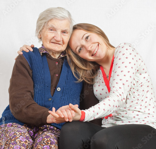 Photo: The sweet young girl and the old woman staying together The sweet young girl and the old woman staying together