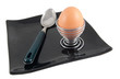 spoon and boiled egg on black plate