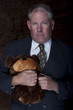 Businessman Clutching a Teddy Bear