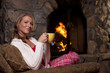 Woman With Tea Sitting By Fireplace Woman With Tea Sitting By Fireplace