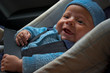 happy newborn in car seat