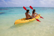 young couple kayaking in hawaii young couple kayaking in hawaii