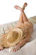 Naked woman sunbathing on beach