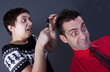 Woman examining man's hair with magnifying glass Woman examining man's hair with magnifying glass