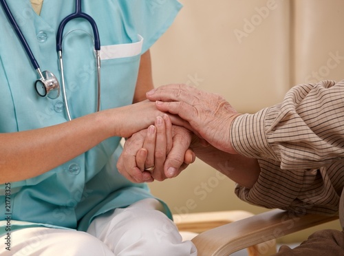 Photo: Hands of nurse and elderly patient. Hands of nurse and elderly patient.