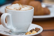 a cup of cappuccino with foam and cinnamon
