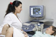 Doctor scanning of a stomach of pregnant woman