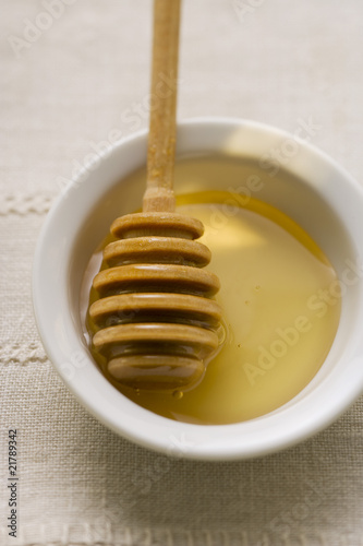 Photo: Honey dipper in a small bowl of honey Honey dipper in a small bowl of honey