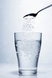 Sprinkling salt into a glass of water