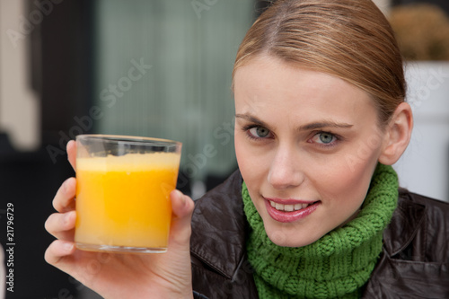 Photo: young woman with a glass of orange juice young woman with a glass of orange juice