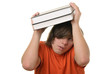 Scared teenager holds some books over head