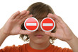 Teenager holds prohibiting signs before eyes