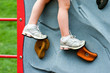 Closeup Child's Legs on Rock Wall