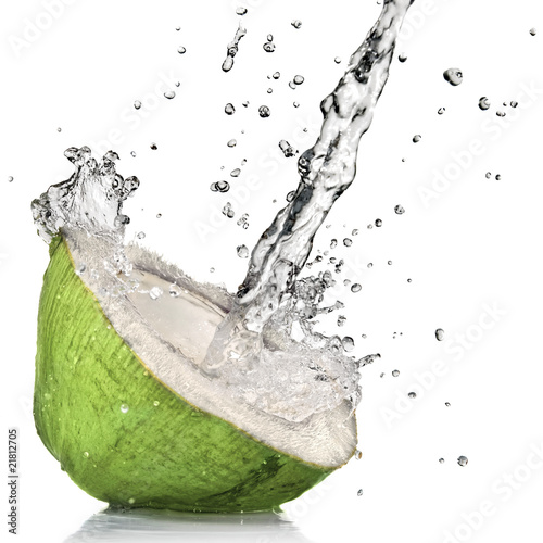 Photo: Green coconut with water splash isolated on white Green coconut with water splash isolated on white