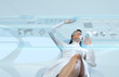 Sexy brunette wearing white suit logging into the system