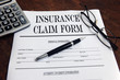 blank insurance claim form and pen