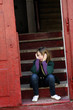 lonely child waiting on stairs