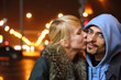woman is kissing her man. focus on man's face.