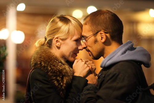 Photo: man and woman is cuddling in coldly nightly fall city man and woman is cuddling in coldly nightly fall city