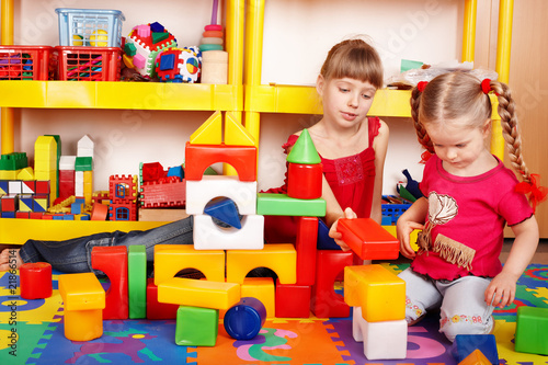 Photo: Child with block and construction set in play room. Child with block and construction set in play room.