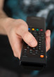 Hand holding TV remote control Hand holding TV remote control