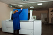 a woman works on a printing factory, ctp