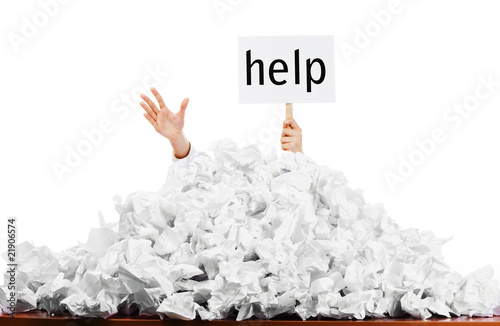 Photo: Person in pile of papers Person in pile of papers