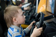 Boy in the children's amusement arcade. Video game.