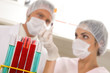 Tubes with scientists in the background