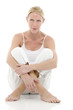 Photo: young woman dressed in white sitting on the floor young woman dressed in white sitting on the floor