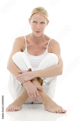 Photo: young woman dressed in white sitting on the floor young woman dressed in white sitting on the floor