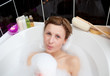 Young woman playing in a bubble bath Young woman playing in a bubble bath