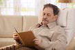 Senior man reading book