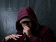 rapper wearing hood and singing to a microphone rapper wearing hood and singing to a microphone