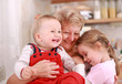 Foto : Cute little boy and little girl happy with grandmother Cute little boy and little girl happy with grandmother