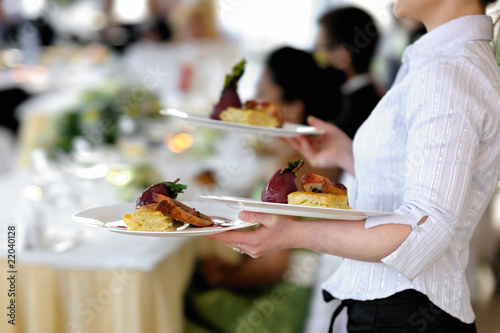 Photo: Waitress is carrying three plates Waitress is carrying three plates