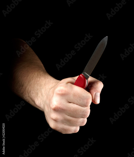 Photo: Knife in hand isolated on black background Knife in hand isolated on black background