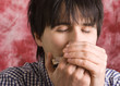 Young handsome man playing harmonica