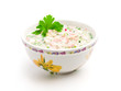 Bowl of cold soup with chopped vegetables, potherbs, meat and kv