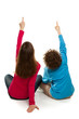 Girl and boy sitting and pointing