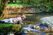 Adventurer lying next to a river Adventurer lying next to a river
