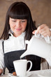 Foto: Beautiful woman is preparing tea Beautiful woman is preparing tea