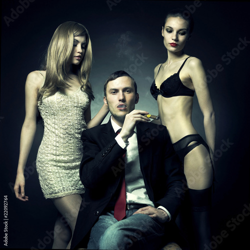 Photo: Handsome man and two women Handsome man and two women