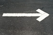 White arrow on asphalt White arrow on asphalt