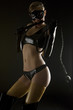 woman wearing latex clothes with whip
